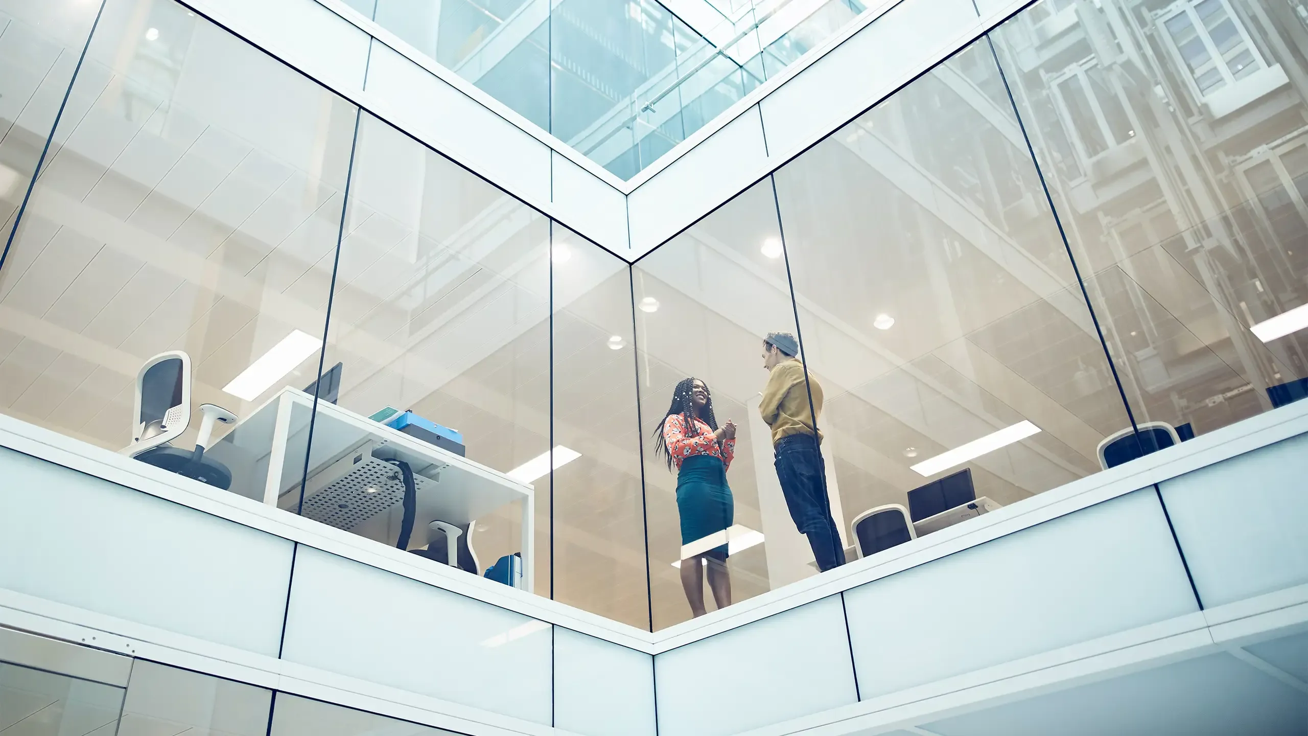 Colleagues talking in a modern office space.