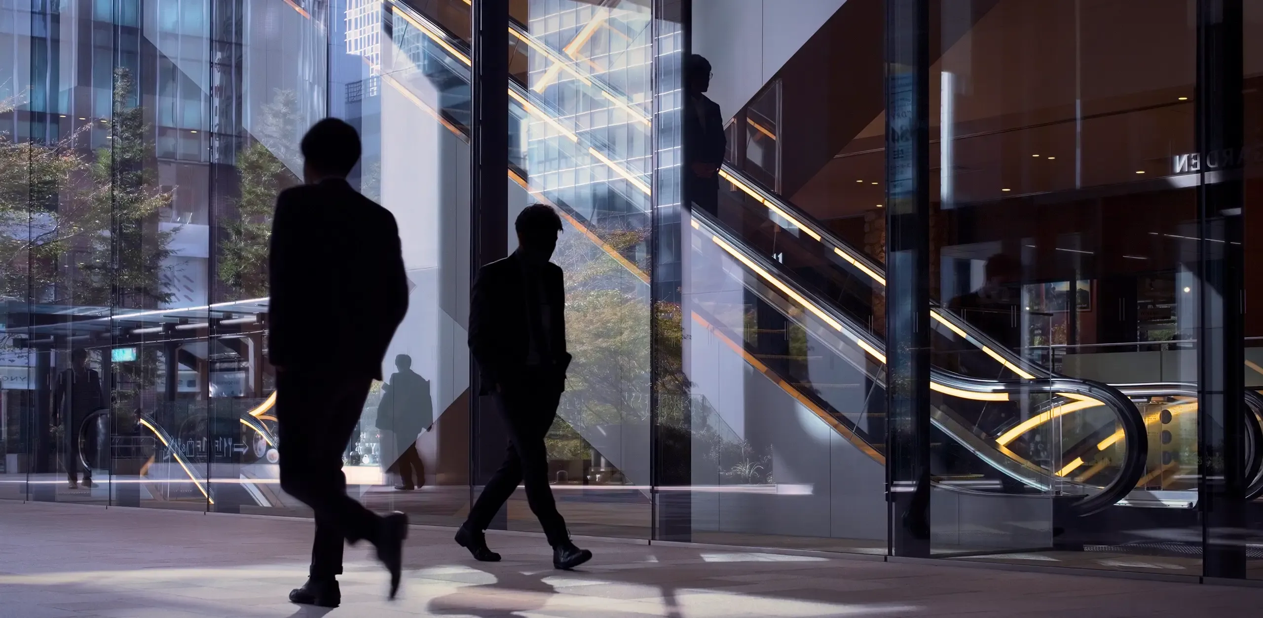 Silhouetted workers in a modern office setting. 